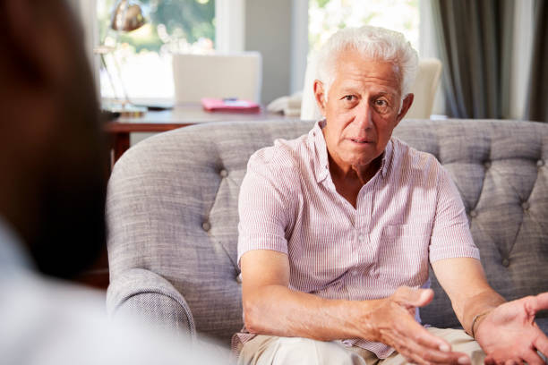 istock Senior man with depression having therapy with psychologist 944582318