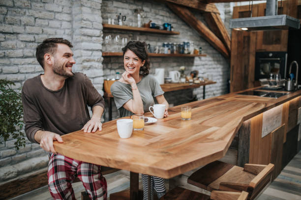 istock Young happy couple having fun during morning coffee in the kitchen. 944582398