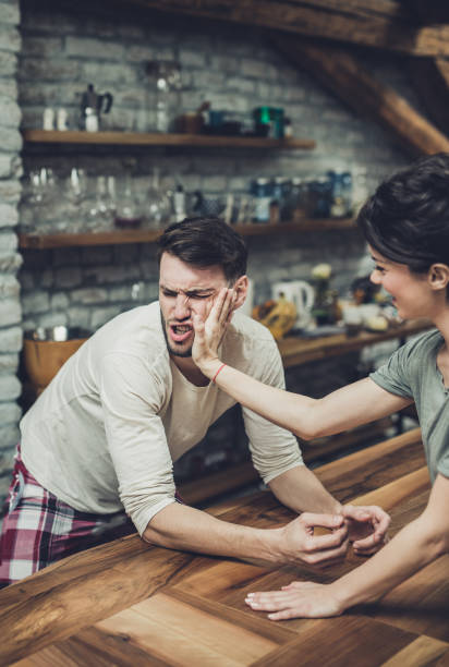 istock Young man getting painful slap from his girlfriend at home. 944584940