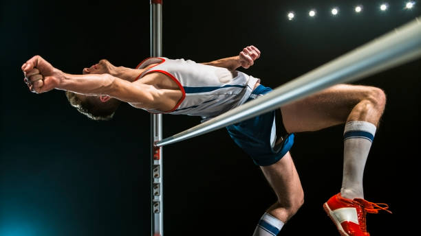 Professional pole vaulter training at the stadium in the evening. Sports banner. Horizontal copy space background