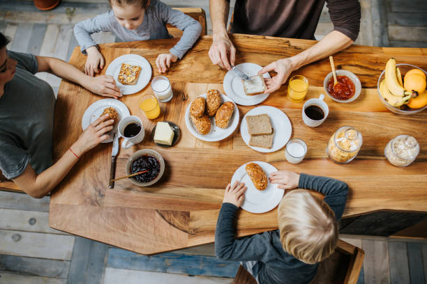 istock Above view of a family having breakfast at dining table. 944585246