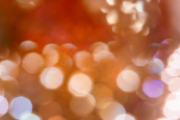 sfondo luce sfocata astratta - defocused illuminated glitter orange foto e immagini stock