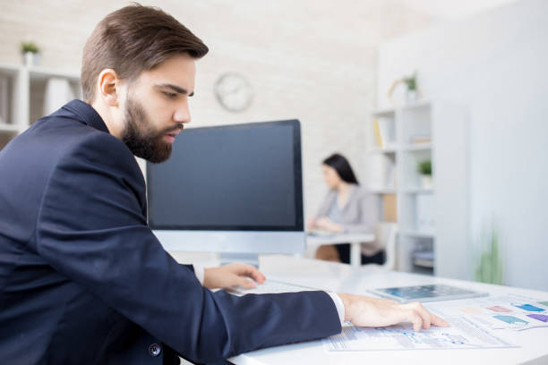 istock Serious financial expert viewing papers 944588316