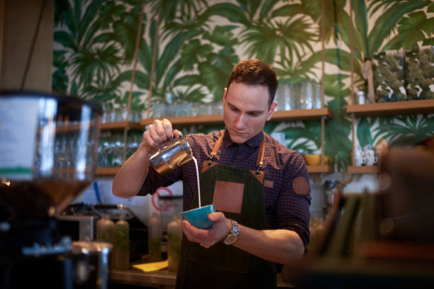 istock Barista in coffee shop 944588412
