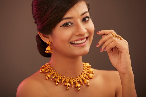 Attractive Indian young women portrait with Indian traditional jewelry in studio shot.
