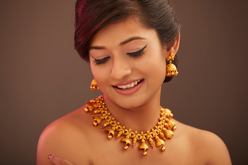 Attractive Indian young women portrait with Indian traditional jewelry in studio shot.