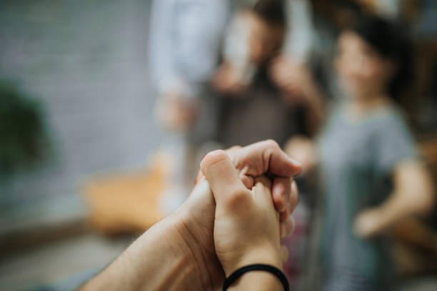 istock Close up of unrecognizable couple holding hands. 944588878