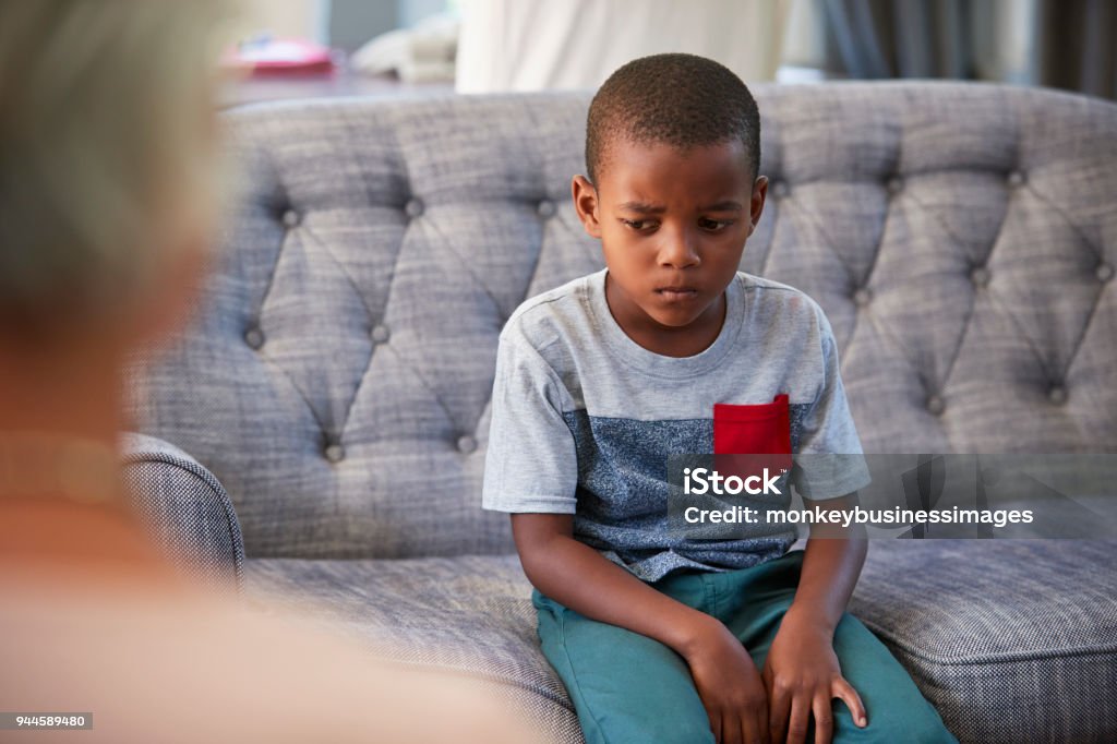 Young boy having therapy with a child psychologist Mental Health Professional Stock Photo