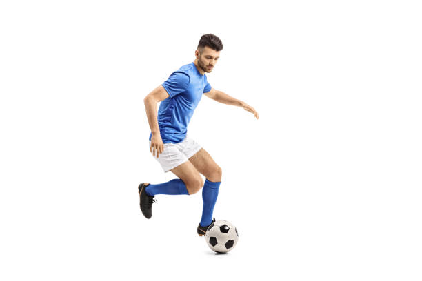 Soccer player dribbling Full length portrait of a soccer player dribbling isolated on white background bouncing stock pictures, royalty-free photos & images