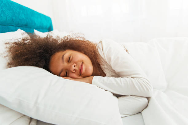 Cute girl sleeping in the bed stock photo