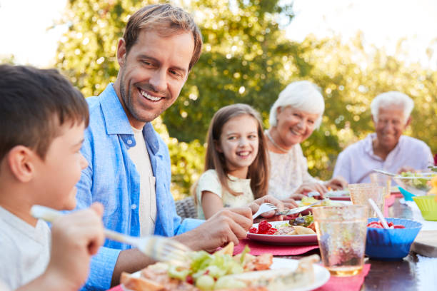 istock Three generation family having lunch in the garden 944597258