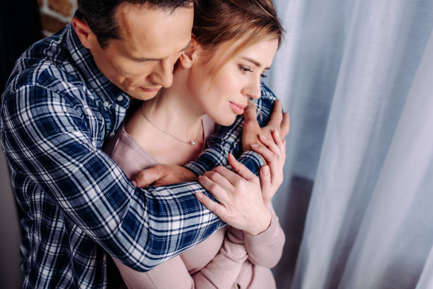 istock high angle view of husband hugging wife at home 944600466