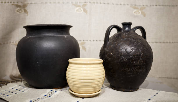 istock Old ceramic brown pot on a white tablecloth on a table 944601486