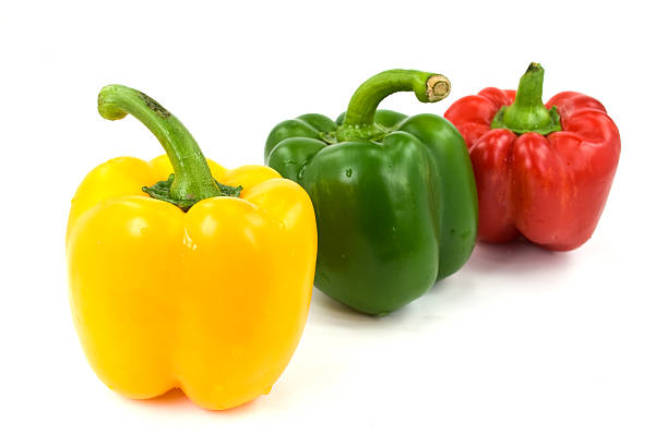 istock Red, green and yellow bell peppers isolated on white 94460176