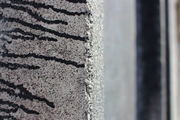 istock concrete grunge fence texture with black paint. Macro Stone grungy slabs construction 944605564