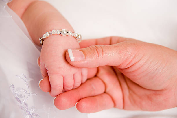 Holding Hands  baby bracelet stock pictures, royalty-free photos & images