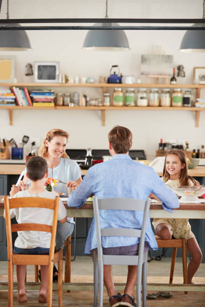 istock Family having lunch together in their kitchen, vertical 944613498