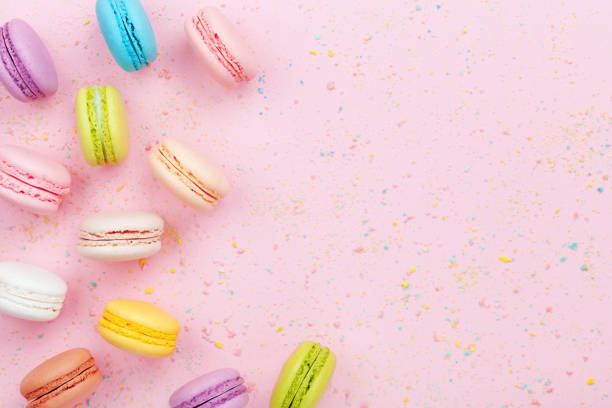 istock Dessert cake macaron or macaroon on pink background top view. Flat lay. 944613984