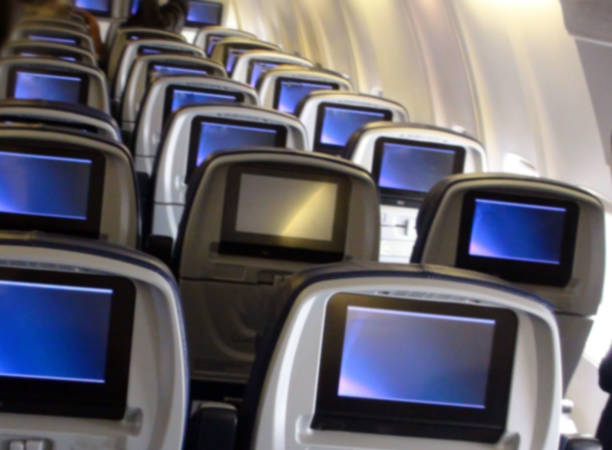 istock Looking At Interior Of Passengers Airplane With Screen 944615830