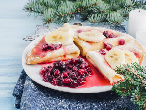 istock Tasty pancakes with a banana, maple syrup and cranberries 944619122
