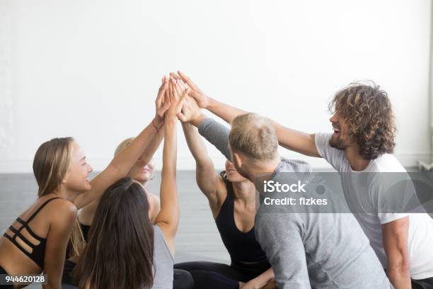 Group Of Fit Happy People Giving High Five Stock Photo - Download Image Now - Celebration, Men, Outdoors