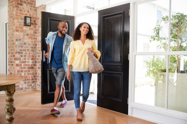 Young mixed race couple arriving at home