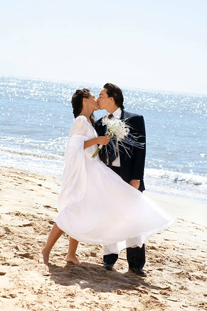 istock Bride kissing groom at the beach 94462177