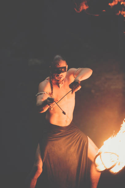 istock Awesome fire show at the waterfall. Brutal muscle man 944622722