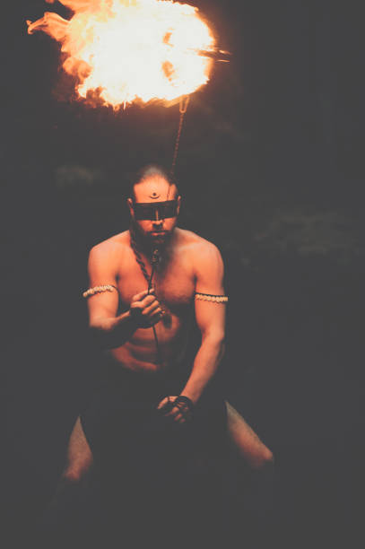 istock Awesome fire show at the waterfall. Brutal muscle man 944622808