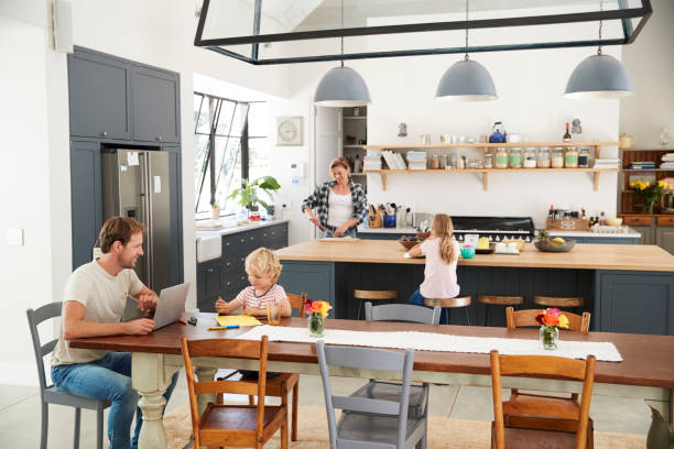 istock Young white family busy in their kitchen, elevated view 944623368