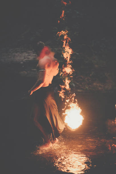 istock Awesome fire show at the waterfall. Brutal muscle man 944623524