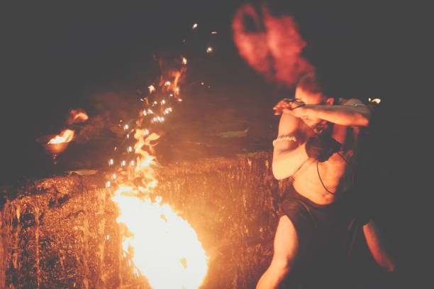 istock Awesome fire show at the waterfall. Brutal muscle man 944623652