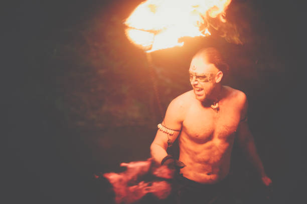 istock Awesome fire show at the waterfall. Brutal muscle man 944623834