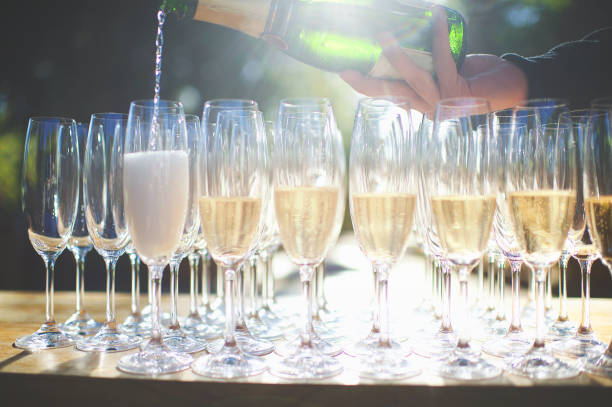 istock Pouring of champagne into glasses 944623858