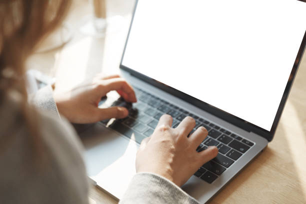 istock Women using laptop with blank screen at table in the office. 944624126