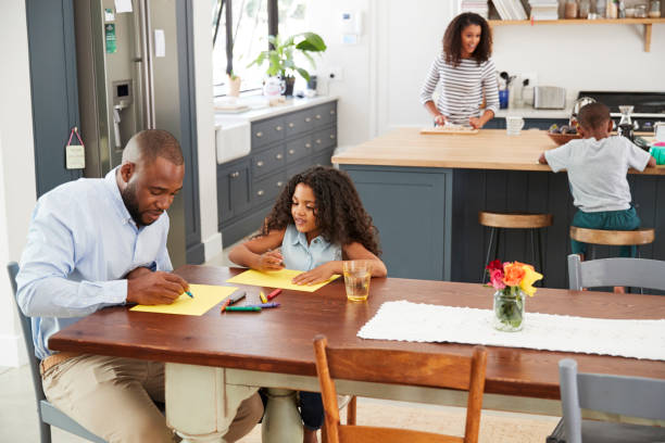 istock Young black family busy in their kitchen, elevated view 944626230