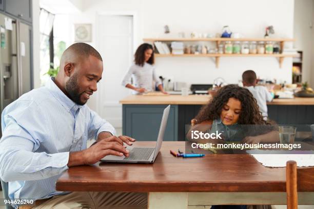 Young Black Family Busy Working In Their Kitchen Stock Photo - Download Image Now - Family, Working At Home, Father