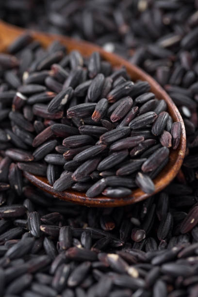 istock Black rice with spoon, macro-photography 944626350