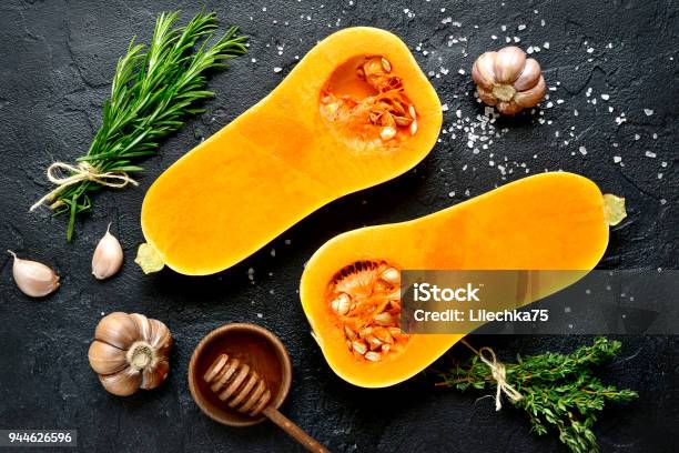 Halves Of Raw Organic Butternut Squash With Spices And Ingredients For Making Stock Photo - Download Image Now
