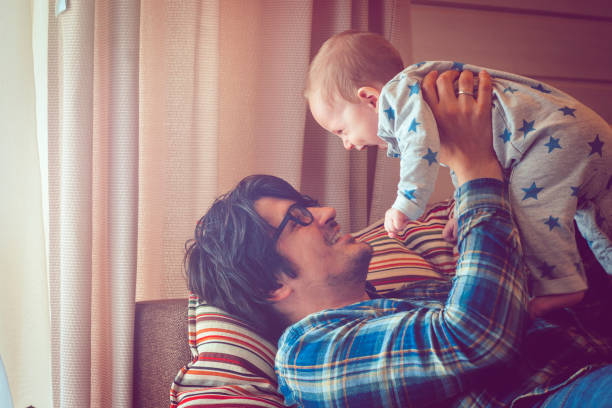 istock Father and baby having fun at home 944634642