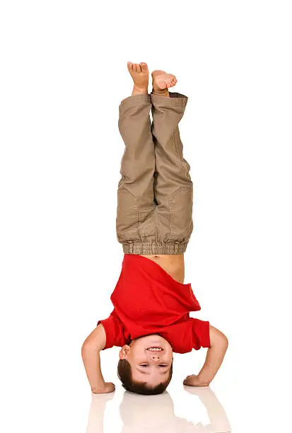 Photo of child standing on his arms