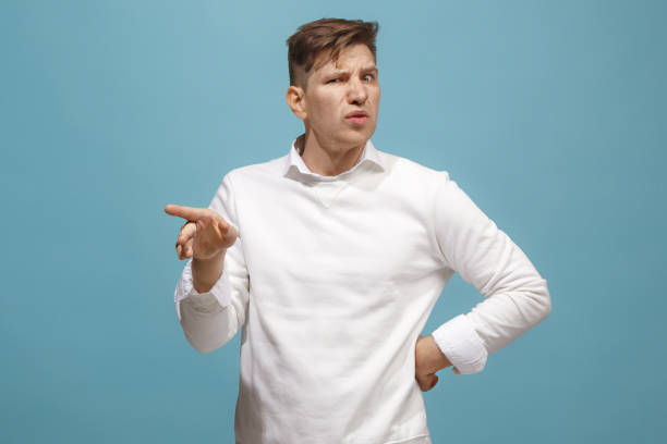 istock Young man with disgusted expression repulsing something, isolated on the blue 944637636