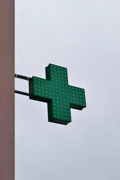 istock Green cross on cloudy sky background. 944638802