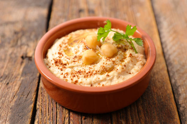istock hummus on wood background 944639402