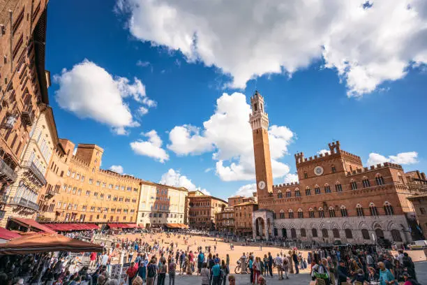 A view of crowds in Siena's Piazza del Campo, an historic town square in the heart of the Tuscan city of Siena.