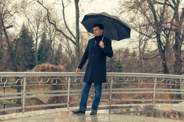istock A man in a coat walks in the spring park 944651142