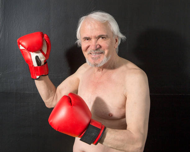 An elderly boxer prepares for a duel Close-up portrait of an elderly boxer preparing for a duel with an opponent.
Elderly people keep fit, regularly exercising in the box in the gym. old man boxing stock pictures, royalty-free photos & images