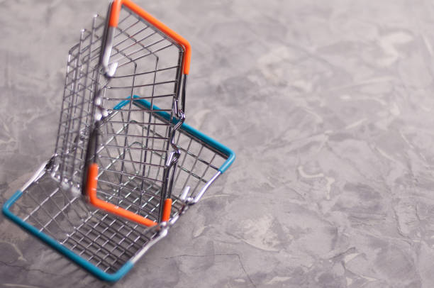 istock One basket with orange handles in another basket with blue rubber handles on cracked old gray cement with copy space 944655942
