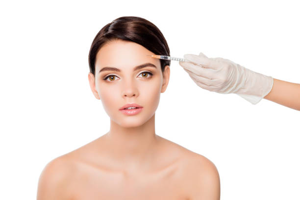 istock Plastic surgery concept. Botox injection in woman's eyebrow 944656378