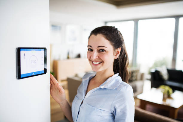 istock A woman looking at tablet with smart home screen. 944657062